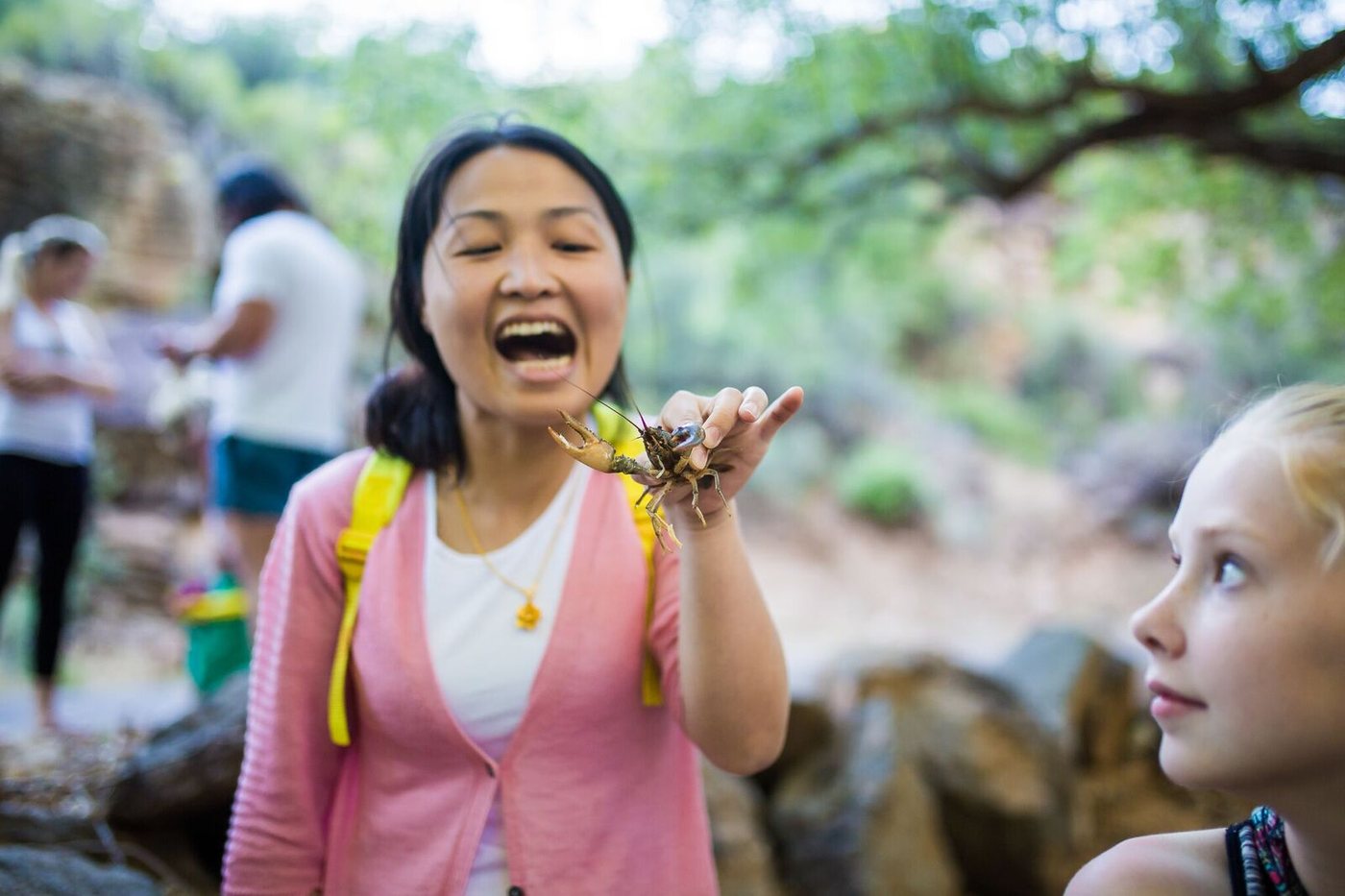 Kids showing off the crawdads they caught in the creek