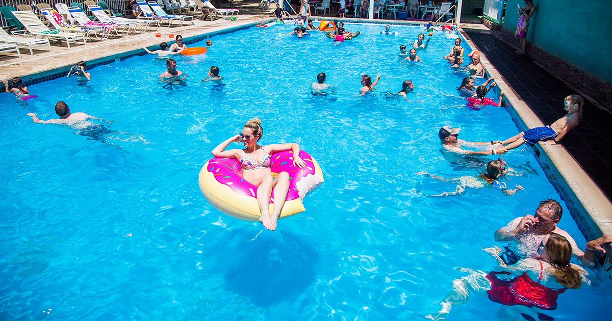 Photograph of people swimming, relaxing and playing at Veyo Pool.